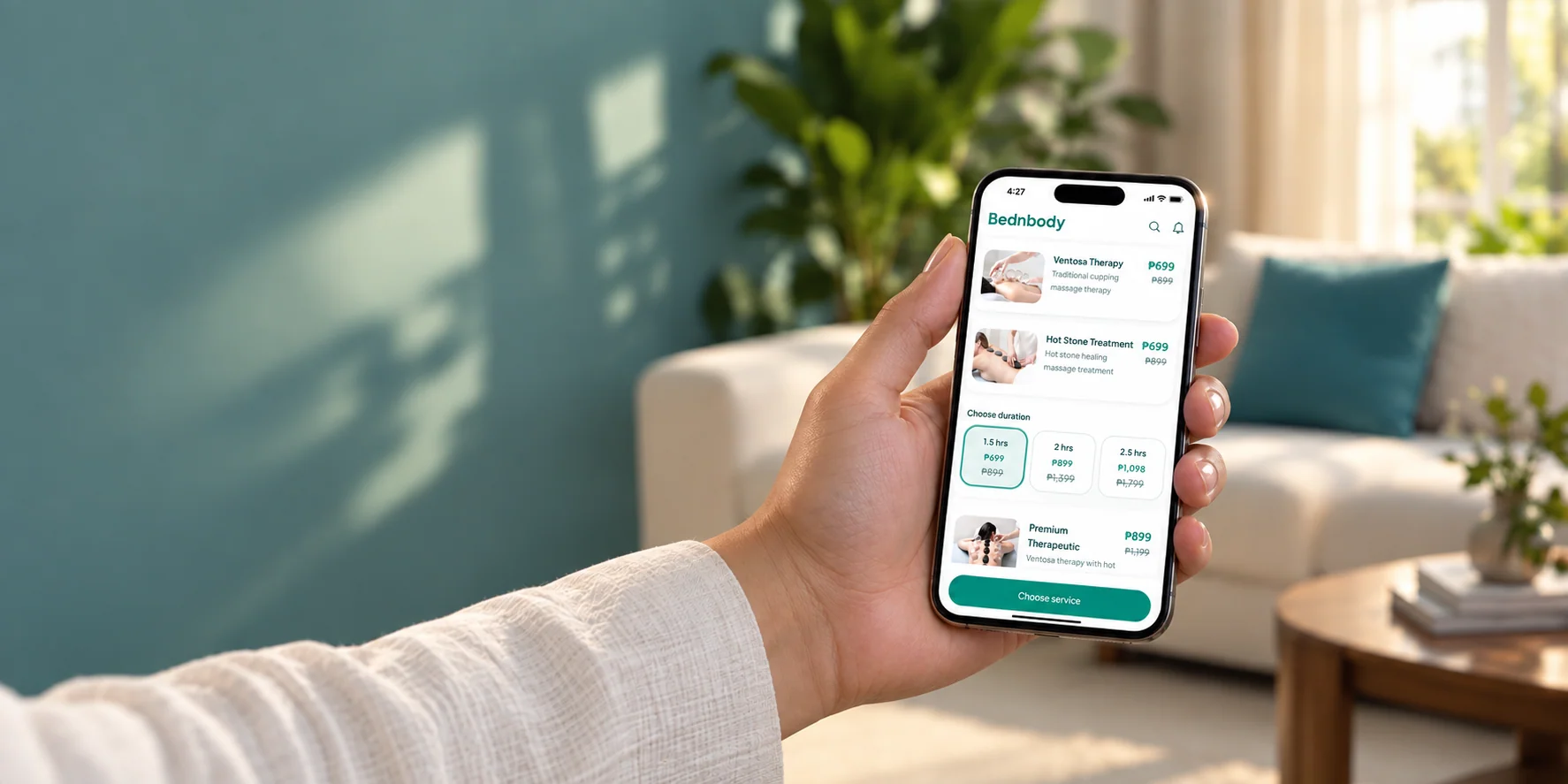 A client holding a phone displaying Bednbody massage services in her home.