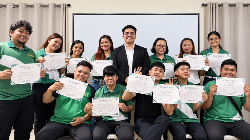 Training participants holding their certificates together