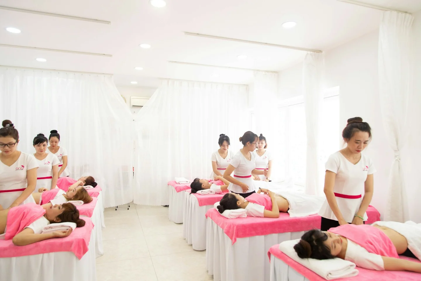 Bright massage room with several prepared massage tables