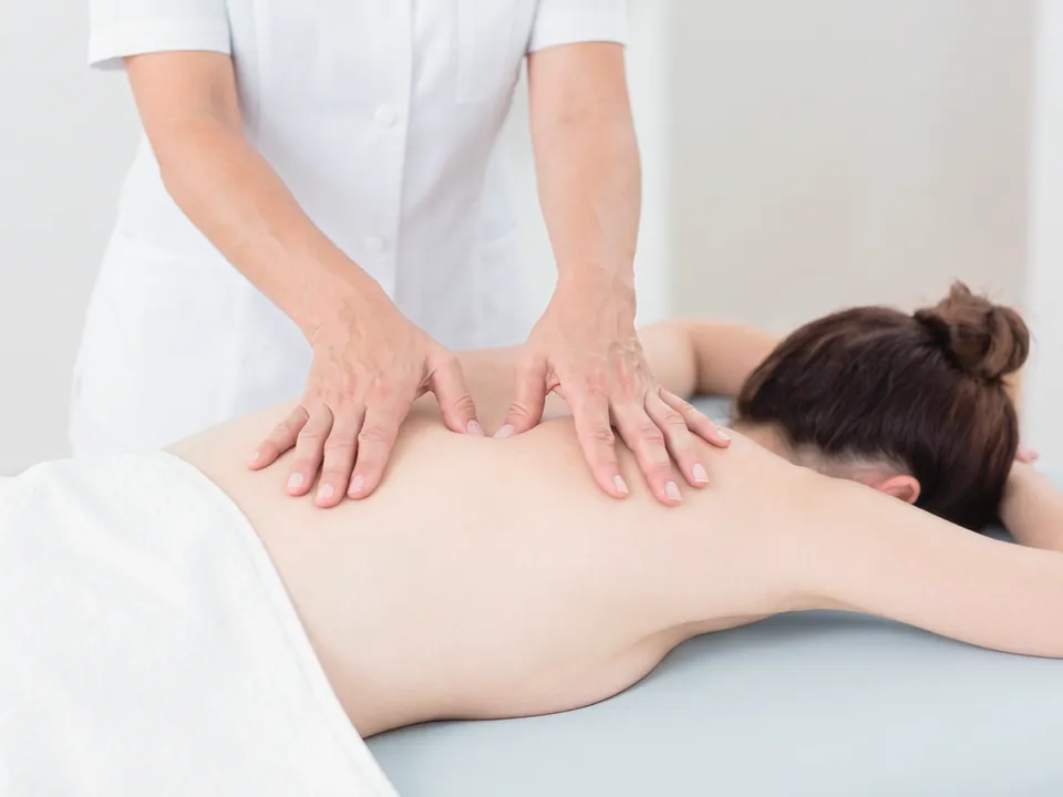 Professional therapist giving a full body massage