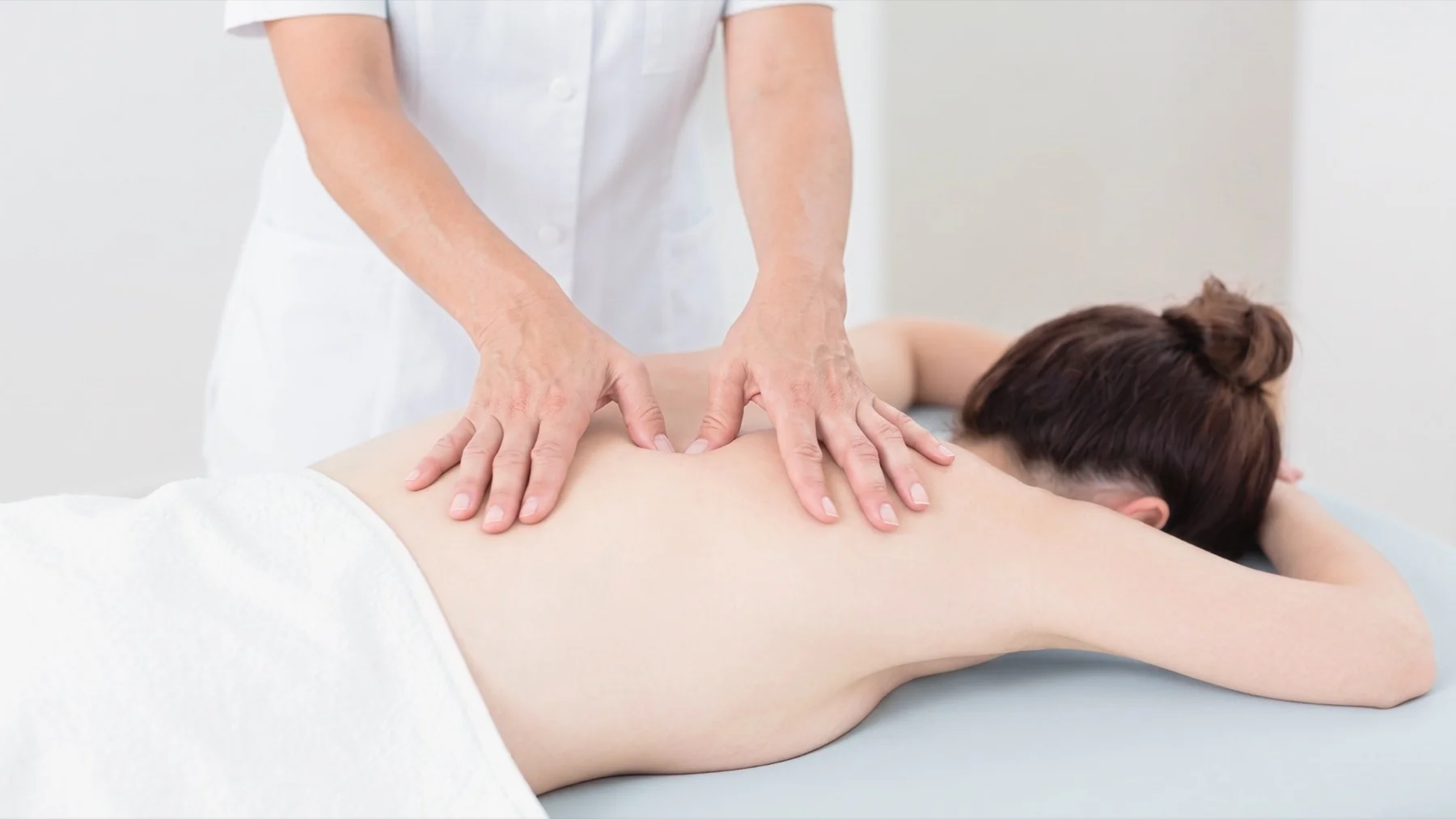 A professional Bednbody massage therapist performing a relaxing full body massage in a comfortable Filipino home